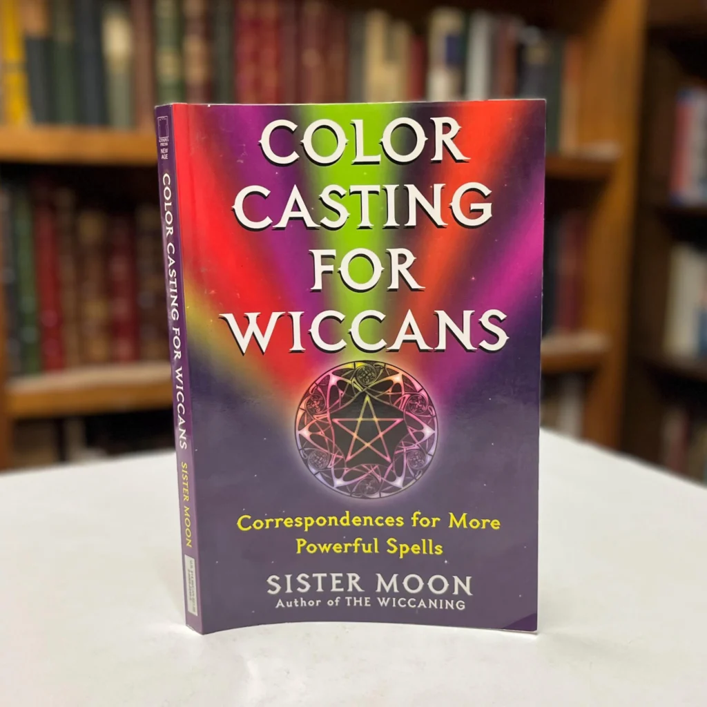Cover of the book “Color Casting for Wiccans: Correspondences for More Powerful Spells” by Sister Moon displayed on a table in a bookstore.