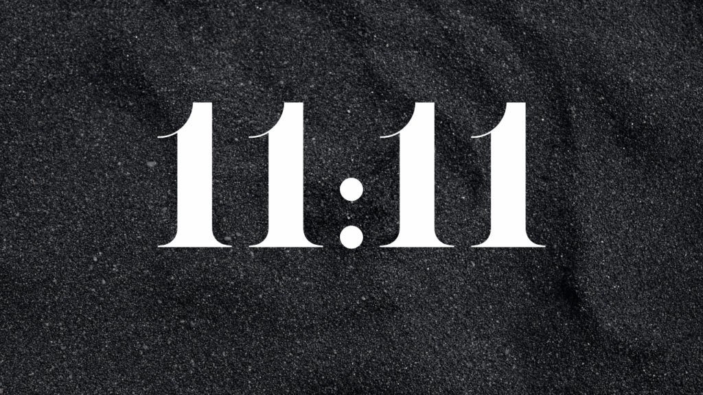 The numbers 11:11 displayed on a dark background represent the energy of the 11/11 Portal and its spiritual gateway for transformation.