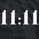 The numbers 11:11 displayed on a dark background represent the energy of the 11/11 Portal and its spiritual gateway for transformation.