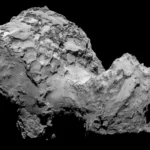 3200 Phaethon Rock Comet surface close-up showing rugged, rocky terrain with deep shadows and fractured features against a black background.